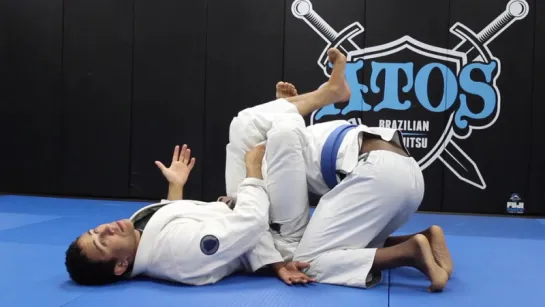 set up the omoplata from the spider collar guard - Dom Bell