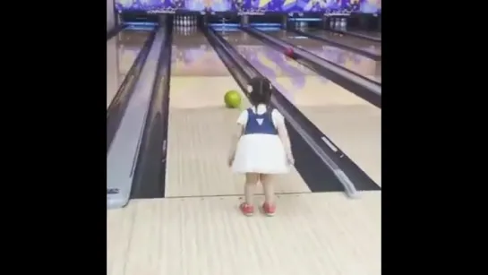 Little girl knock strike in bowling