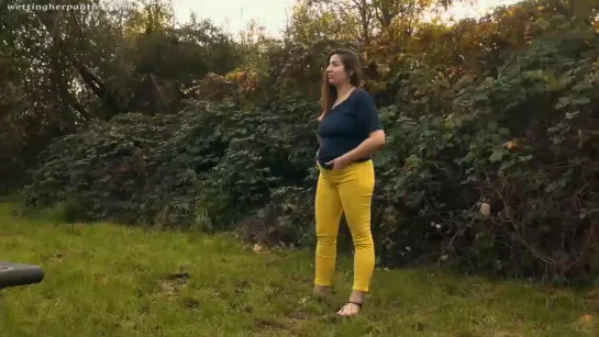 Pee in yellow jeans in the backyard