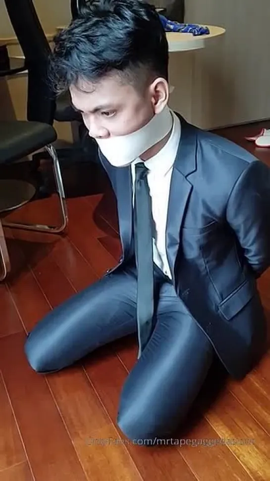 A boy  tied up and gagged by white microfoam tape.