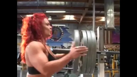 Muscular woman bending steel after hard workout