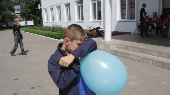 blowing blue balloon to pop