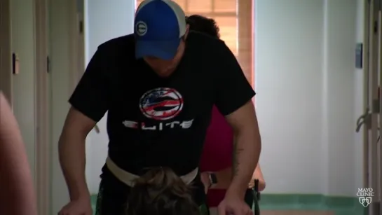 Spinal cord stimulation, physical therapy help paralyzed man stand, walk with assistance