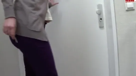 WOMAN PEES HER PURPLE PANTS IN FRONT OF HER HOME