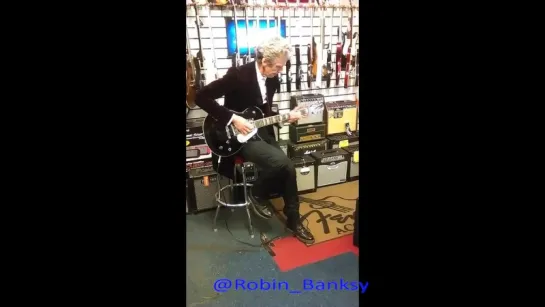 Peter Capaldi Rockin' in a music shop in Cardiff in June 2015