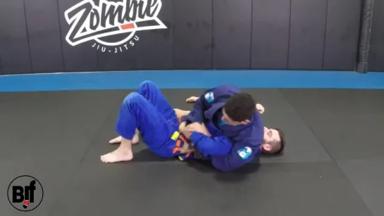 Defending kimura from bottom half guard