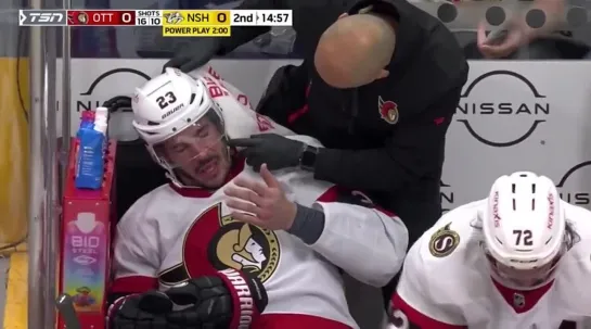 Thomas Chabot accidentally smacks Travis Hamonic in the face with his stick on the bench