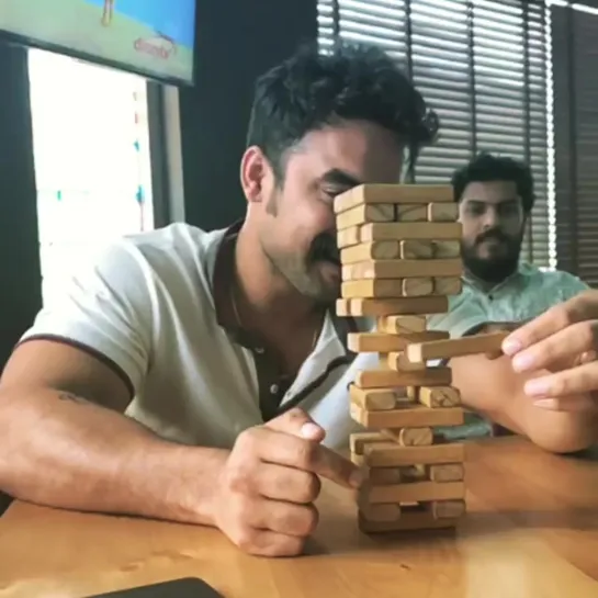 Tovino Thomas plaing jenga