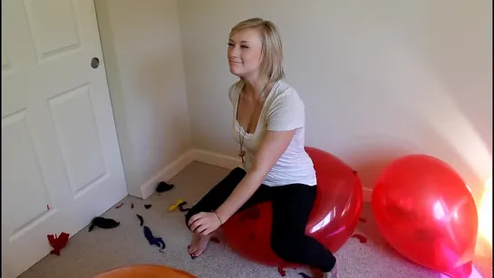 Kourtney popping balloons with nails