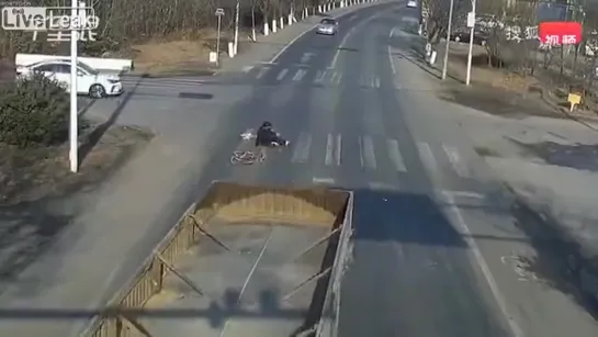 Bicyclist survives when run over by a trucks trailer