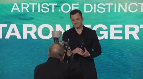 Taron Egerton receiving the Artist of Distinction award at the Newport Beach Film Festival in London (February 16th, 2023)