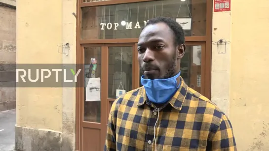 SPAIN: STREET VENDORS TURN BARCELONA SHOP INTO COVID-19 GOWN AND MASK WORKSHOP.