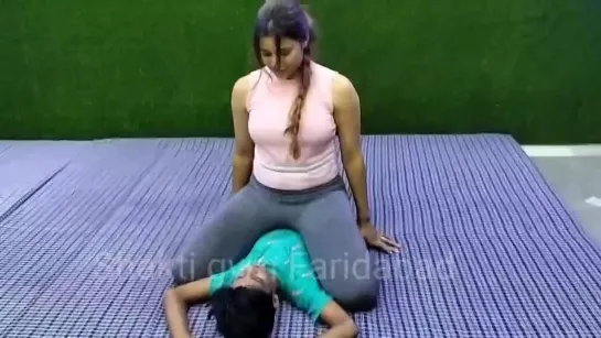 Pretty Indian woman sits on little man.