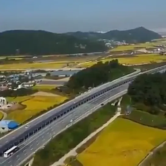 In South Korea , the solar panels in the middle of the highway have a bicycle path underneath - cyclists are protected from the