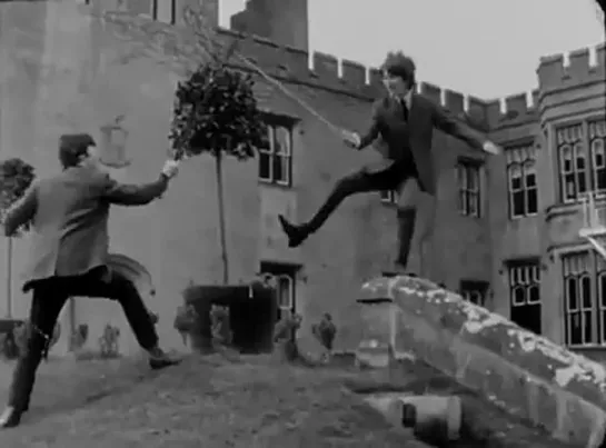 John Lennon and George Harrison battle with swords at Dromoland Castle, Ireland where they spent their Easter break, March 1964.