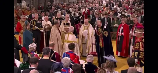 The Prince of Wales pays homage to his father before kissing The King on the cheek. - - Coronation