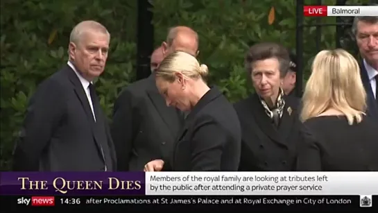 Members of the Royal Family look at tributes left by the public