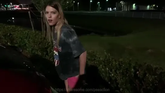 Cute blonde pee spraying next to the car at night time