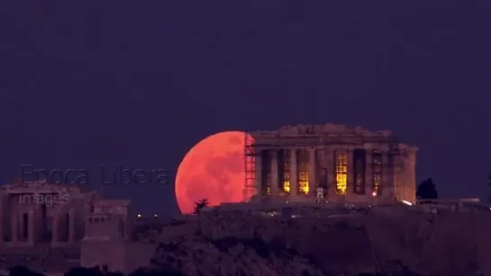 super blue blood moon rises behind parthenon