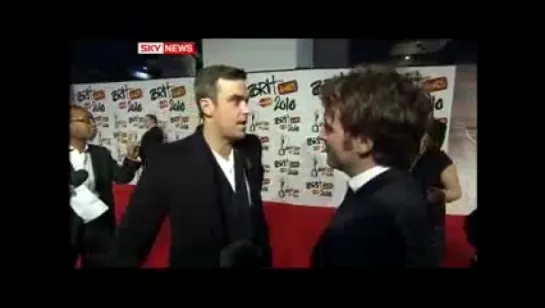 Robbie Williams Plugs Sky On Red Carpet At BRIT Awards