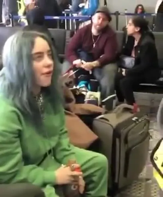 billie with a fan at the airport