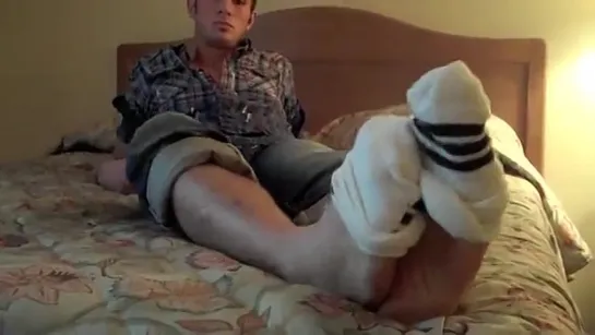 Derek taking off his socks with his toes