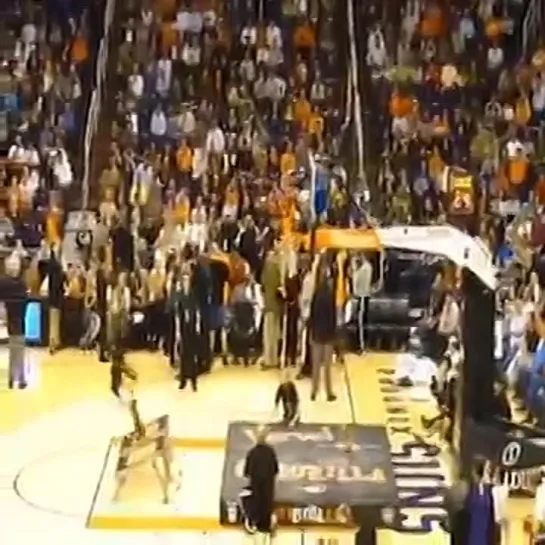 Guy dunks himself through the net at a halftime show