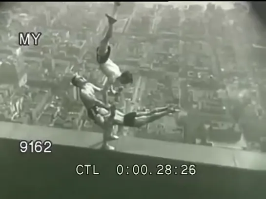 Acrobats balance on top of the Empire State Building, 1934