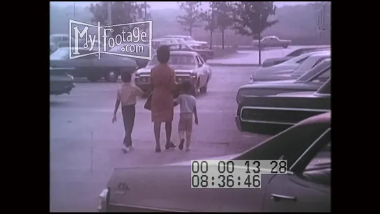 1970s Family Bringing Groceries To the Car