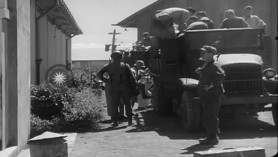 Rescued Allied prisoners line up to get their names checked while a woman holds a...HD Stock Footage