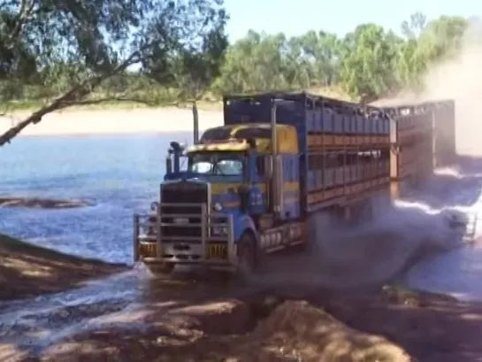 Road Train going flat-out over a river crossing - Western Australia