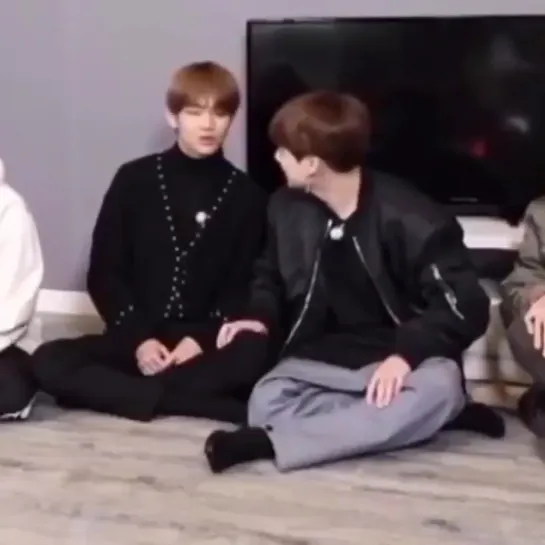 jungkook putting his hand on taehyungs leg and then both of them laughing over the word dr