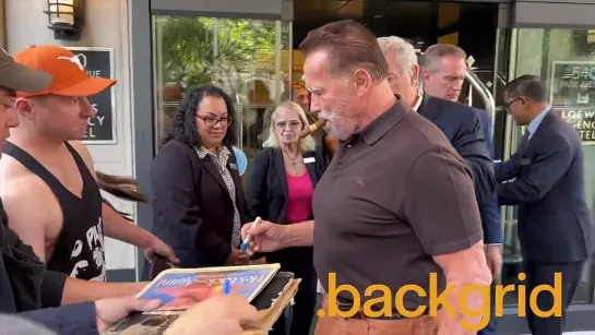 Arnold Schwarzenegger signed a Mr. Olympia poster outside the Loews Regency