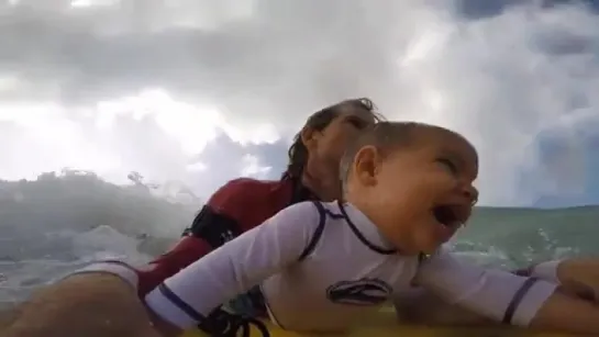 Father Bodyboarding with Baby Son