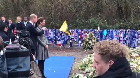 Prince William and Kate pay their respects in front of the thousands of flowers that have