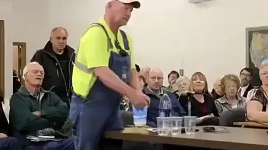 A farmer in Nebraska asking a pro-fracking committee member to honor his word of drinking water from